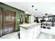 Open concept kitchen featuring granite counters, eat-in island, and green wall accents at 8524 Quarters Ln, Mint Hill, NC 28227