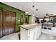 Open concept kitchen with an island featuring granite countertops and modern lighting at 8524 Quarters Ln, Mint Hill, NC 28227