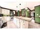 Bright eat-in kitchen features white cabinets, modern appliances and a large center island with granite countertops at 8524 Quarters Ln, Mint Hill, NC 28227