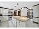 Bright kitchen with white cabinets, stainless appliances, granite counters and tile flooring at 8524 Quarters Ln, Mint Hill, NC 28227