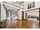 Grand living room with soaring ceilings, hardwood floors, staircase and view into the game room at 8524 Quarters Ln, Mint Hill, NC 28227