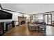 Bright living room featuring a brick fireplace, hardwood floors and backyard access at 8524 Quarters Ln, Mint Hill, NC 28227