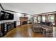 Cozy living room featuring a brick fireplace, comfortable seating, and modern entertainment system at 8524 Quarters Ln, Mint Hill, NC 28227
