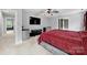 Main bedroom features a ceiling fan, television, and plush red bedding creating a comfortable and inviting retreat at 8524 Quarters Ln, Mint Hill, NC 28227