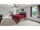 Bright main bedroom featuring a large window, ceiling fan, and adjacent bathroom at 8524 Quarters Ln, Mint Hill, NC 28227
