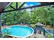 Inviting swimming pool surrounded by a deck, lush greenery, and a charming gazebo at 8524 Quarters Ln, Mint Hill, NC 28227