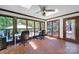 Bright sunroom featuring mosaic tile floors, skylights, ceiling fan, and views to the pool and wooded yard at 8524 Quarters Ln, Mint Hill, NC 28227