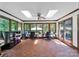 Sunroom with skylights, tile flooring, ceiling fan, large windows and views to backyard at 8524 Quarters Ln, Mint Hill, NC 28227