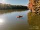 Beautiful view of person in kayak in the lake surrounded by colorful fall trees at 9305 Munsing Dr # 142, Charlotte, NC 28269