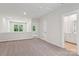 Open loft area features neutral carpet, views to the outside and access to the bathroom at 9305 Munsing Dr # 142, Charlotte, NC 28269