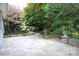 Expansive stone patio with lush greenery, offering a serene outdoor retreat at 9814 Fernspray Rd, Charlotte, NC 28215