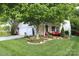 Inviting home exterior with a well-manicured lawn and cozy porch seating, perfect for relaxing outdoors at 9814 Fernspray Rd, Charlotte, NC 28215