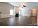 Bright living room boasting hardwood floors, a cozy fireplace, and abundant natural light at 9814 Fernspray Rd, Charlotte, NC 28215