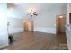 Open-concept living room with vaulted ceilings, hardwood floors, and a cozy fireplace at 9814 Fernspray Rd, Charlotte, NC 28215
