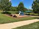 Community playground with a slide, swings, and shaded seating area, perfect for outdoor fun at 9814 Fernspray Rd, Charlotte, NC 28215