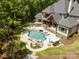 Expansive aerial view showcases the backyard's in-ground pool, spa, waterfalls, patio, and meticulously landscaped yard at 10170 Enclave Cir, Concord, NC 28027