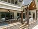 Outdoor covered patio with stairs, featuring a dining area and lounge seating at 10170 Enclave Cir, Concord, NC 28027