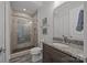 Well-lit bathroom with glass-enclosed shower, granite countertop, and wood cabinets at 10170 Enclave Cir, Concord, NC 28027