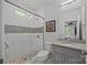 Cozy bathroom featuring tiled shower with glass door, granite countertop, and neutral decor at 10170 Enclave Cir, Concord, NC 28027