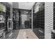 Contemporary bathroom with black tiled shower, rain shower head, and frameless glass enclosure at 10170 Enclave Cir, Concord, NC 28027