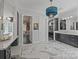 Bright bathroom featuring double vanity, walk-in shower, and adjoining walk-in closet at 10170 Enclave Cir, Concord, NC 28027
