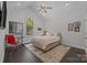 Bedroom features hardwood floors, large window, and neutral decor at 10170 Enclave Cir, Concord, NC 28027