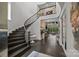 Spacious foyer with curved staircase, dark wood floors, and views into the formal living room at 10170 Enclave Cir, Concord, NC 28027