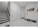 Bright foyer features designer tile flooring, staircase, and coat rack with built-in bench at 10170 Enclave Cir, Concord, NC 28027