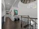 Elegant hallway with a decorative chandelier, wood floors, and staircase at 10170 Enclave Cir, Concord, NC 28027
