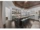 Gourmet kitchen features a large island, stainless steel appliances, custom cabinetry, and plenty of counter space at 10170 Enclave Cir, Concord, NC 28027