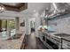 This kitchen boasts stainless steel appliances, custom backsplash, granite countertops, and views to the backyard at 10170 Enclave Cir, Concord, NC 28027