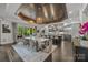 Open concept kitchen and dining area with stainless steel appliances, large island and access to the outdoor patio at 10170 Enclave Cir, Concord, NC 28027