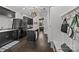 Laundry room with modern washer and dryer units, storage, and a granite countertop folding area at 10170 Enclave Cir, Concord, NC 28027