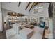 Open-concept living area with vaulted ceilings, fireplace, bar and views of the staircase at 10170 Enclave Cir, Concord, NC 28027