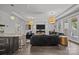Open-concept living room with hardwood flooring, modern lighting, and bar seating at 10170 Enclave Cir, Concord, NC 28027