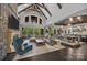 Elegant living area with stone fireplace, vaulted ceilings, and expansive windows at 10170 Enclave Cir, Concord, NC 28027