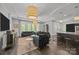 Spacious living room features modern lighting, hardwood floors, and a bar area at 10170 Enclave Cir, Concord, NC 28027