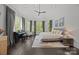 Spacious main bedroom with bay window, piano, and hardwood floors at 10170 Enclave Cir, Concord, NC 28027