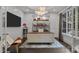Modern office with custom shelving, a designer desk, and a large window at 10170 Enclave Cir, Concord, NC 28027