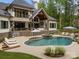 The backyard features a stunning swimming pool with a waterfall, jacuzzi, and several lounge chairs for relaxation and recreation at 10170 Enclave Cir, Concord, NC 28027