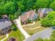 Expansive aerial view of the home featuring a pool, lush greenery, beautiful landscaping, and a large driveway at 10327 Oak Pond Cir, Charlotte, NC 28277