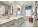 Elegant bathroom featuring double sinks, patterned wallpaper, stylish fixtures, and a separate shower at 10327 Oak Pond Cir, Charlotte, NC 28277