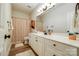 Well-lit bathroom with neutral walls, wood-look flooring, and white cabinets with modern hardware at 10327 Oak Pond Cir, Charlotte, NC 28277