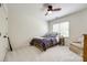 Cozy bedroom with plush carpeting, ceiling fan, and a comfortable twin bed nestled by a window at 10327 Oak Pond Cir, Charlotte, NC 28277