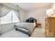 Comfortable bedroom with plush carpeting, soft natural light, and neutral tones, creating a relaxing retreat at 10327 Oak Pond Cir, Charlotte, NC 28277