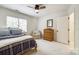 Well-lit bedroom with ceiling fan, plush carpeting, a comfortable chair and natural wood dresser at 10327 Oak Pond Cir, Charlotte, NC 28277