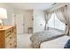 Bright bedroom featuring plush carpeting, a large window with light-filtering drapes, and a cozy, inviting atmosphere at 10327 Oak Pond Cir, Charlotte, NC 28277