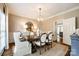 Dining room with a large wooden table, stylish chairs, and a modern chandelier at 10327 Oak Pond Cir, Charlotte, NC 28277
