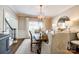 Dining room with a large wooden table, stylish chairs, and a modern chandelier at 10327 Oak Pond Cir, Charlotte, NC 28277
