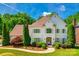 Elegant two-story home featuring a well-manicured lawn, mature trees, and a charming front entrance at 10327 Oak Pond Cir, Charlotte, NC 28277